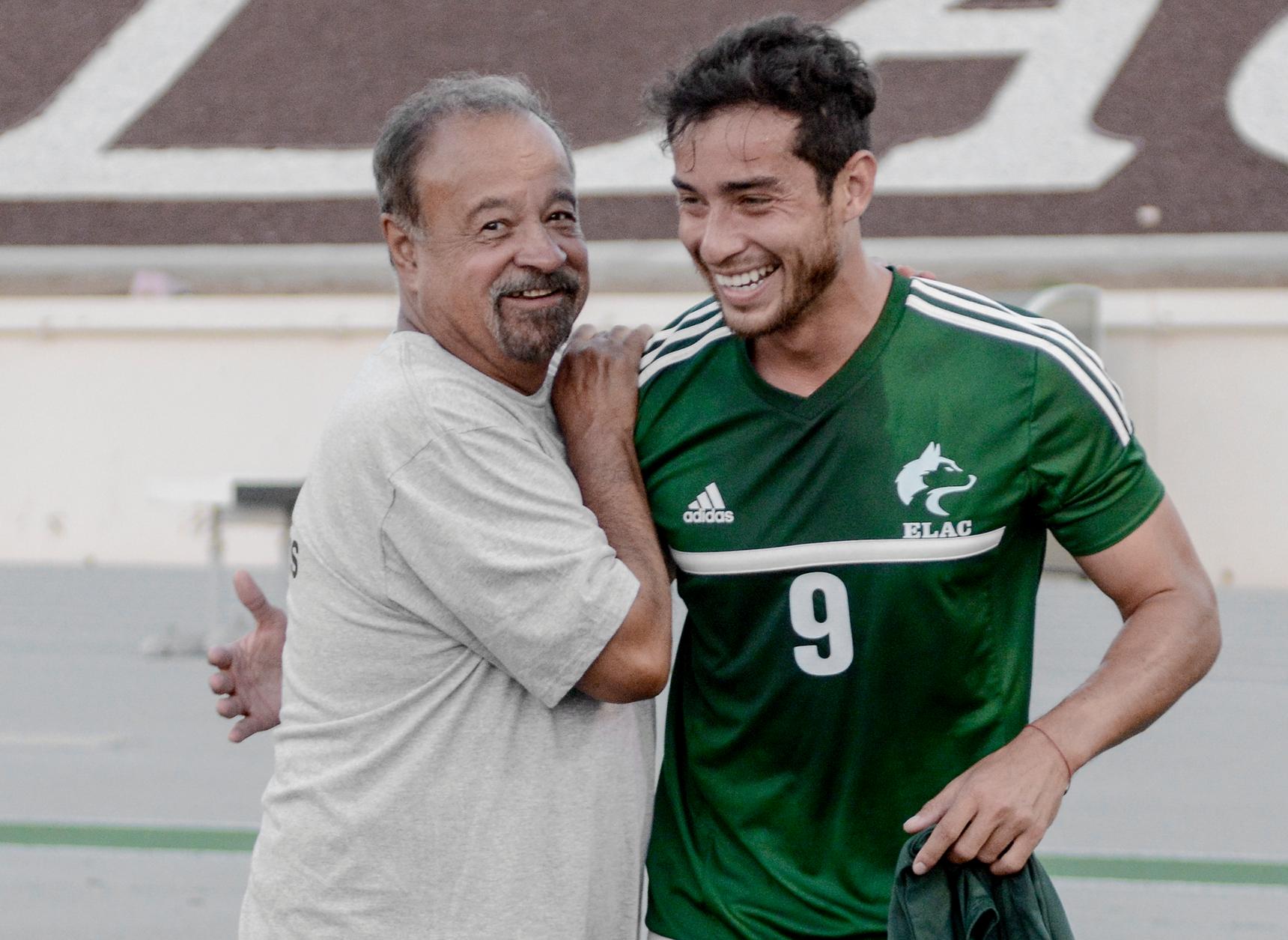 East Los Angeles College sophomore forward Cesar Alvarez is all smiles after a training on Sept. 9 with men's soccer coach Eddie Flores. Alvarez has scored three goals the Huskies this season, two in a recent 3-3 tie vs. LA Harbor College.