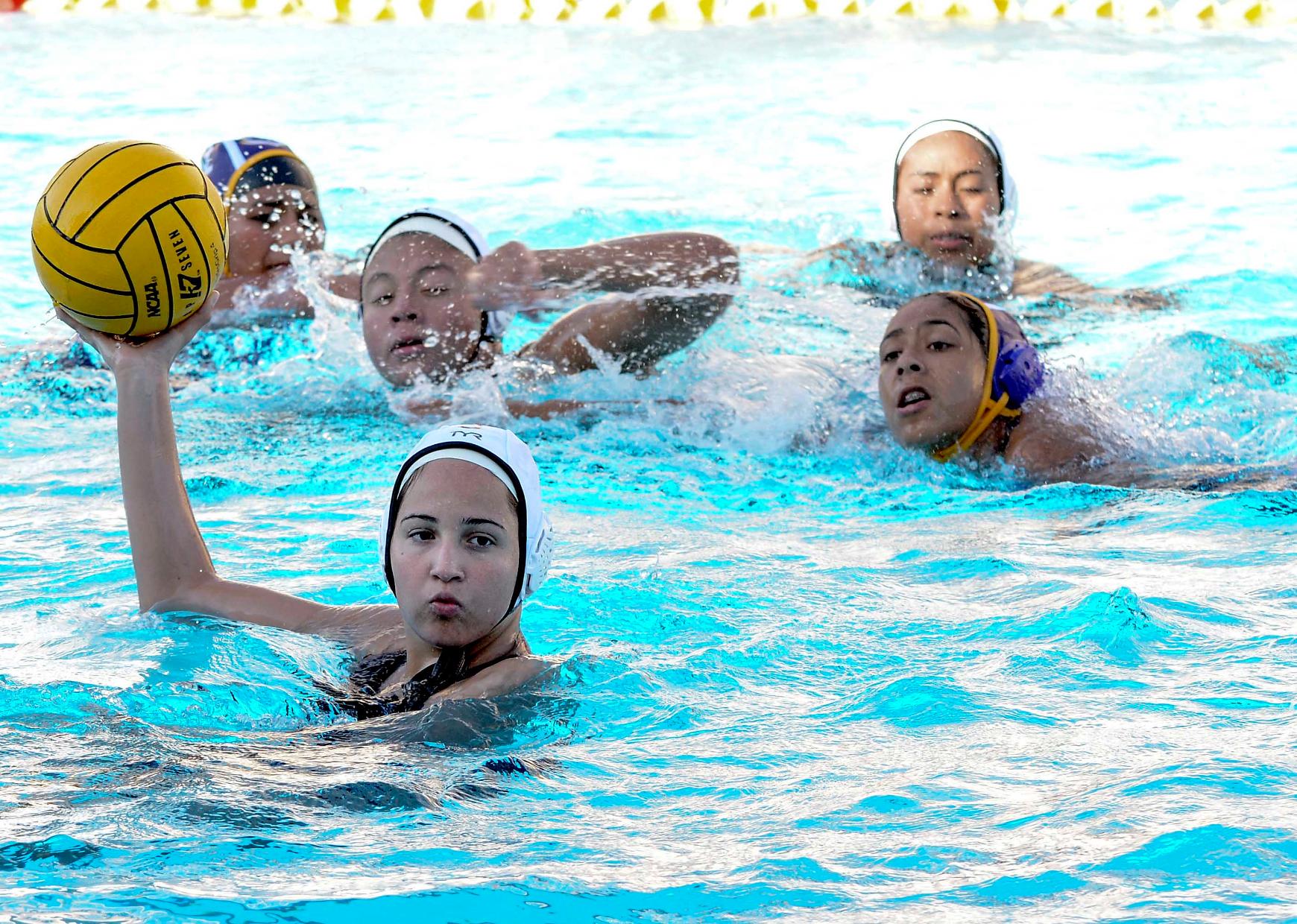 The East los Angeles college water polo team is on offense during a 17-1 win vs. crosstown rival LA Trade Tech on Oct. 5. (Photo by Tadzio Garcia)