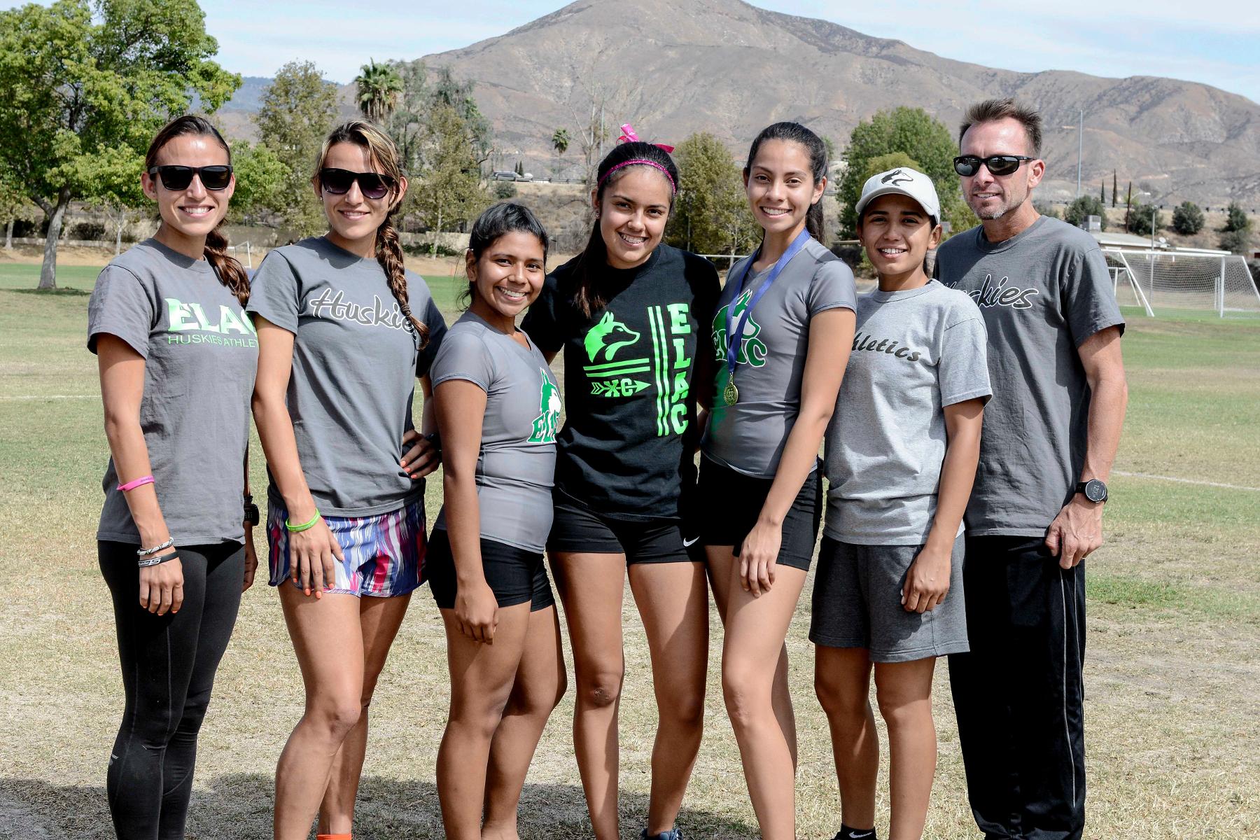 The women's cross country team and coaches pose for a photo in San Bernardino. (Photo by Tadzio Garcia)