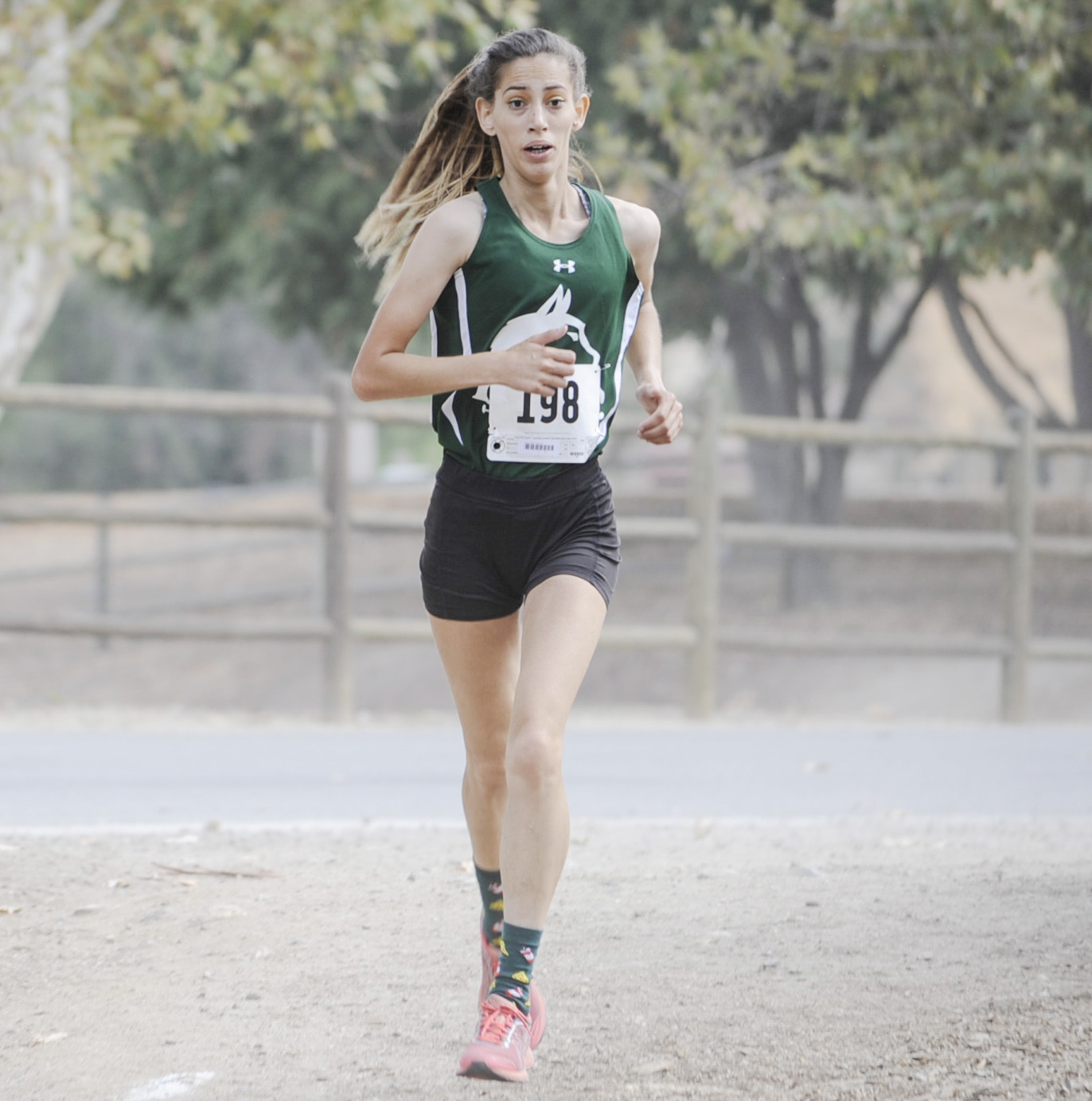 East Los Angeles College freshman Daisy Ortiz eyes the finish line with determination at the SoCal Cross Country Preview Meet. (Photo by Tadzio Garcia)
