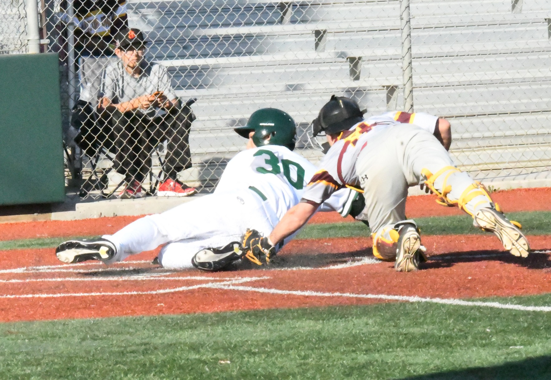 East Los Angeles College freshman first baseman David Lomeli is safe and scores unearned in the bottom of the fourth, in a 6-2 win vs. Victor Valley College on Jan. 31. (Photo by DeeDee Jackson).
