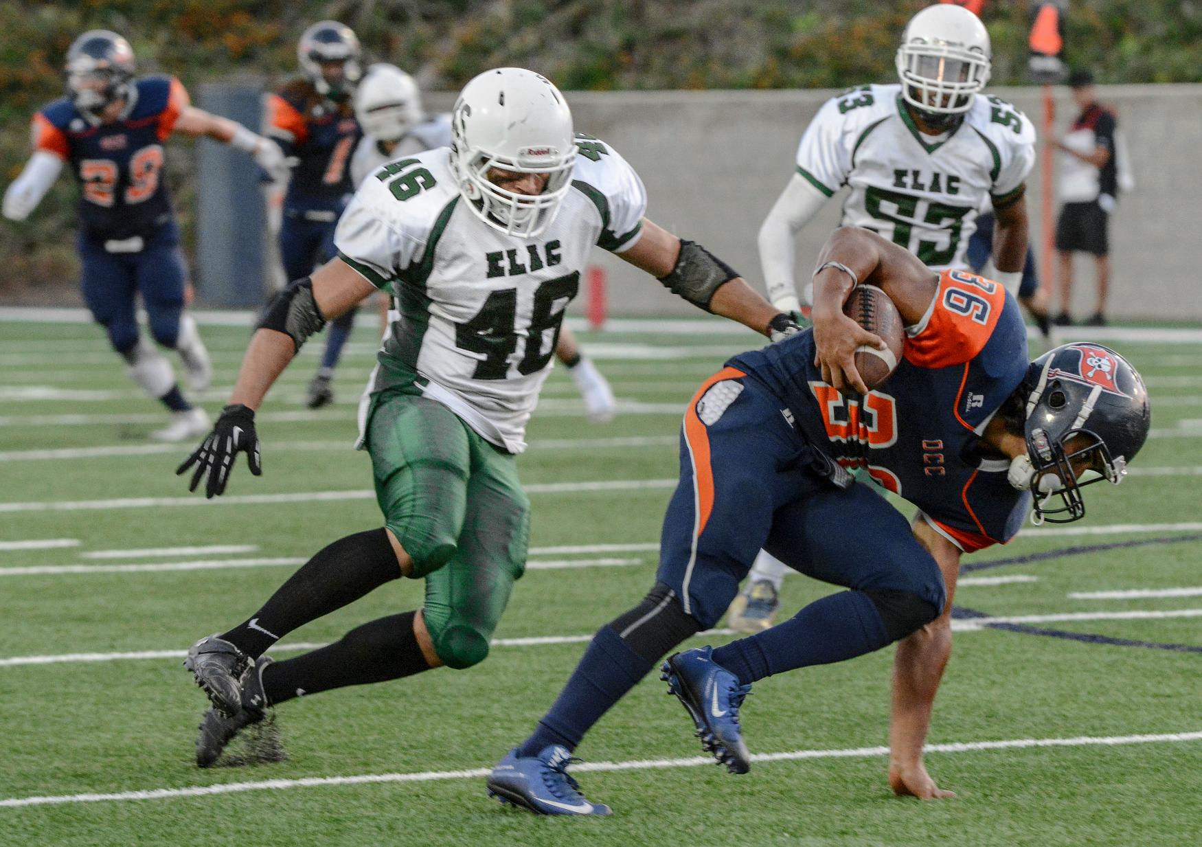 East Los Angeles College sophomore linebacker Anthony Perez (No. 46) reaches out to tackle Orange Coast College freshman running back John Simon as sophomore running back Vaquel Junious Brown looks on in a 27-3 ELAC loss to the Pirates on Sept. 3. (Photo by Tadzio Garcia)