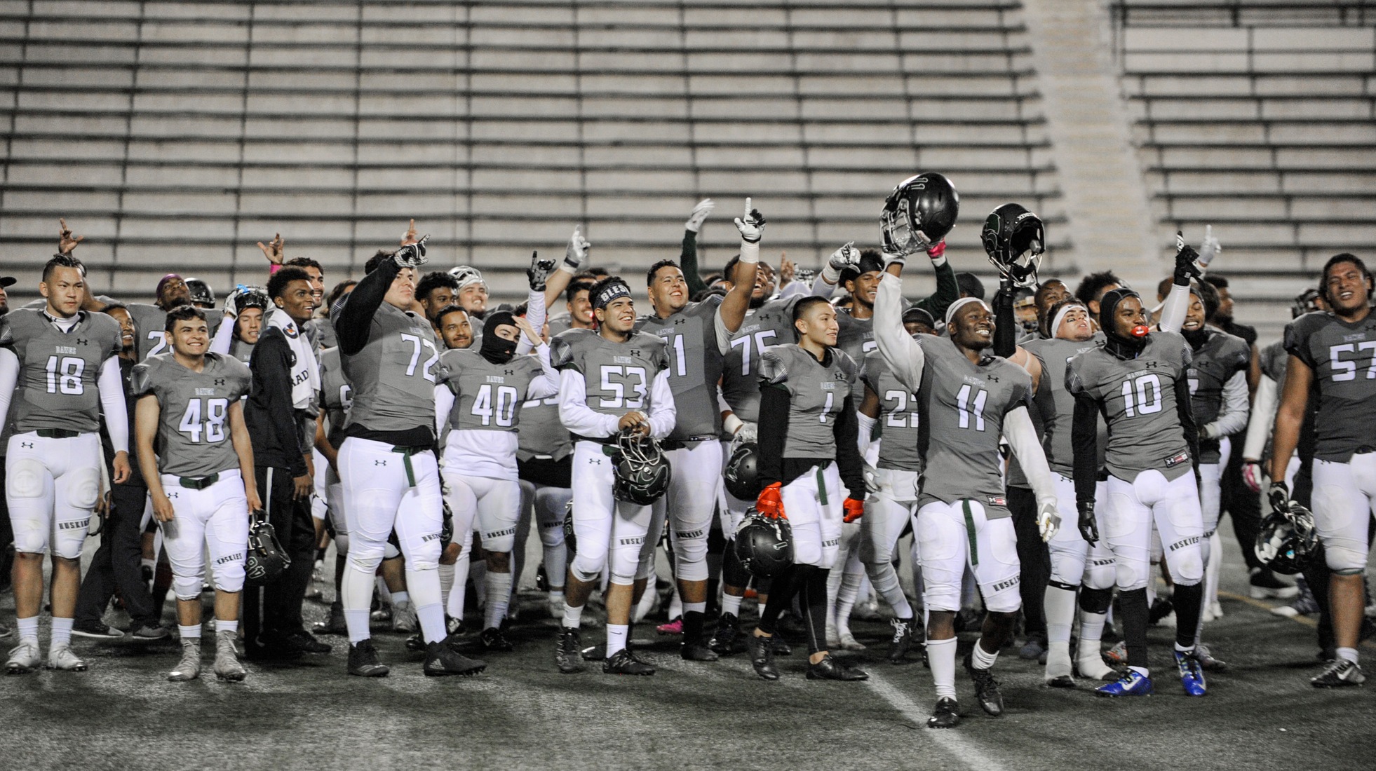 The East Los Angeles College football team reacts to the home crowd giving them a rousing ovation several minutes after the Huskies 20-13 win over Long Beach City College. (Photo by Tadzio Garcia)