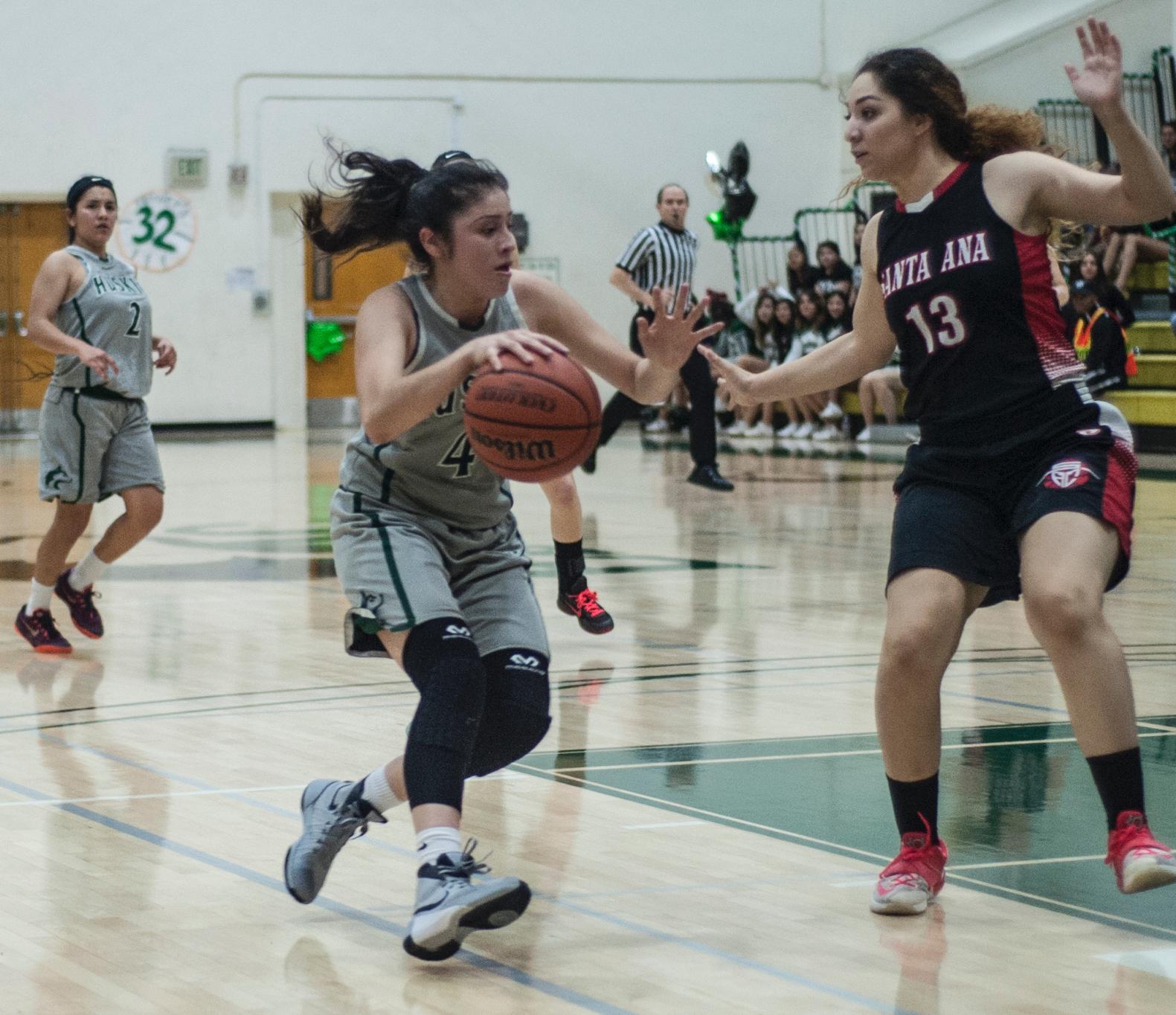 East Los Angeles College freshman guard Allissa Gomez drives towards the paint around Santa Ana College sophomore guard Mercedes Munoz in a 101-94 Huskies win in Round 2 of the playoffs on Feb. 26.  (Photo by Tadzio Garcia)