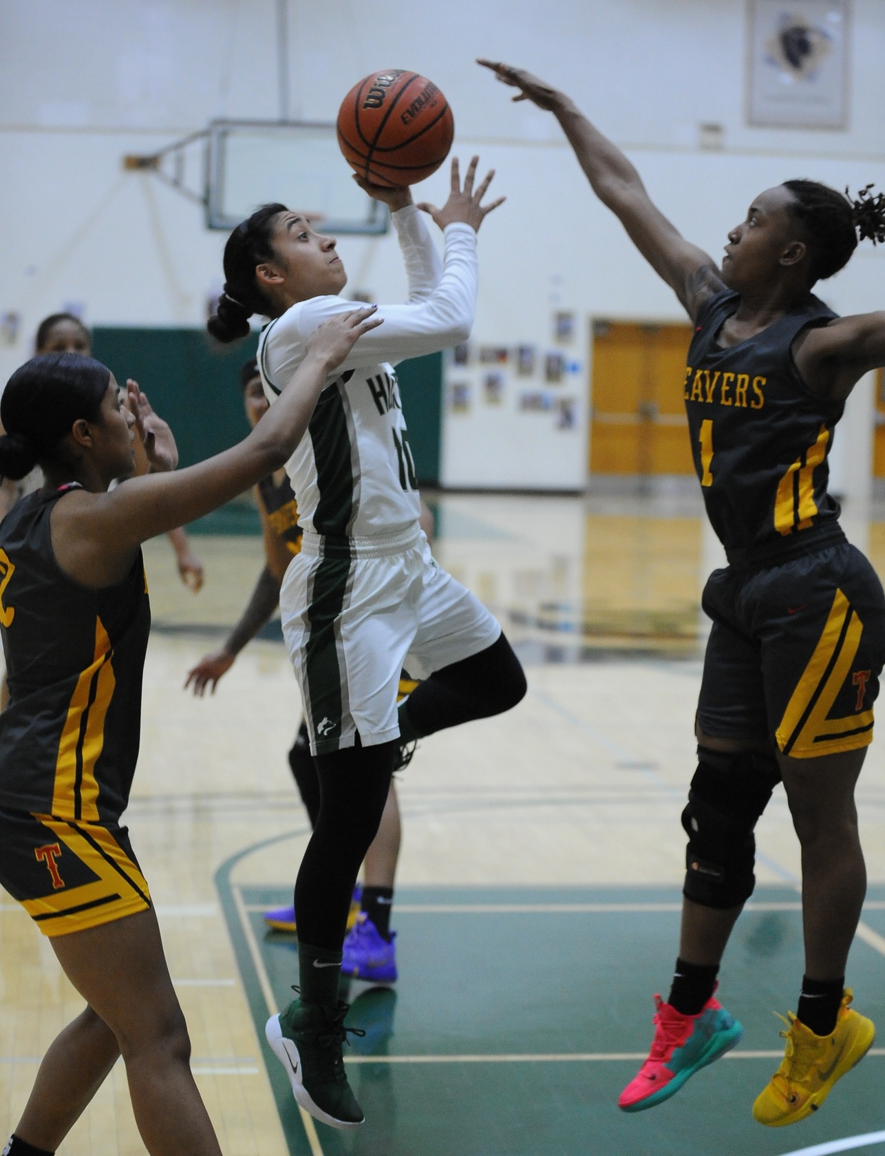 East Los Angeles College guard Jennifer Pool, left goes up to the basket in last Friday’s game versus L.A. Trade Tech.