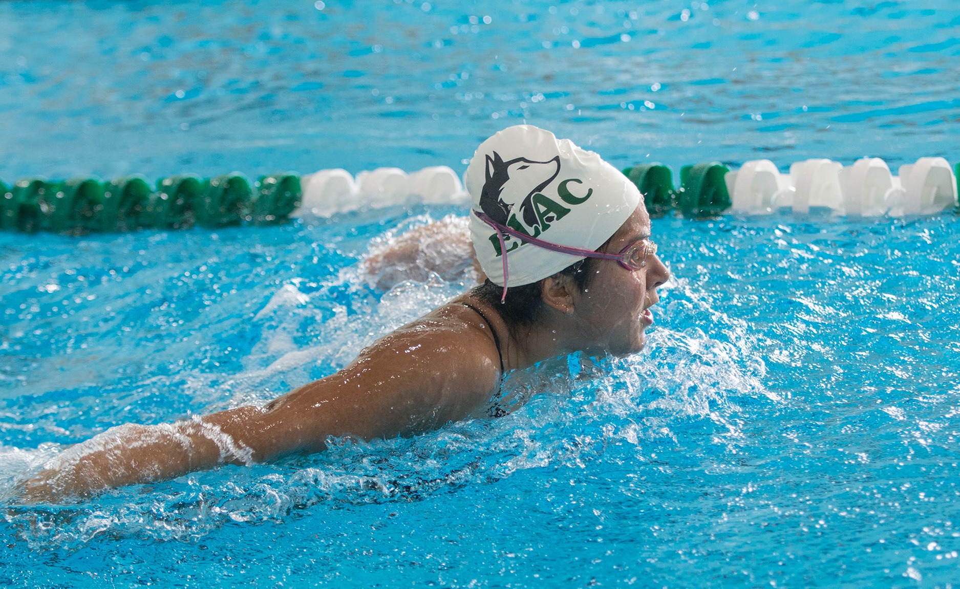 East Los Angeles College freshman Crystal Rubalcava eyes the wall in her first place 200-yard butterfly finish for the ELAC Swim & Dive team. (Photo by Tadzio Garcia)