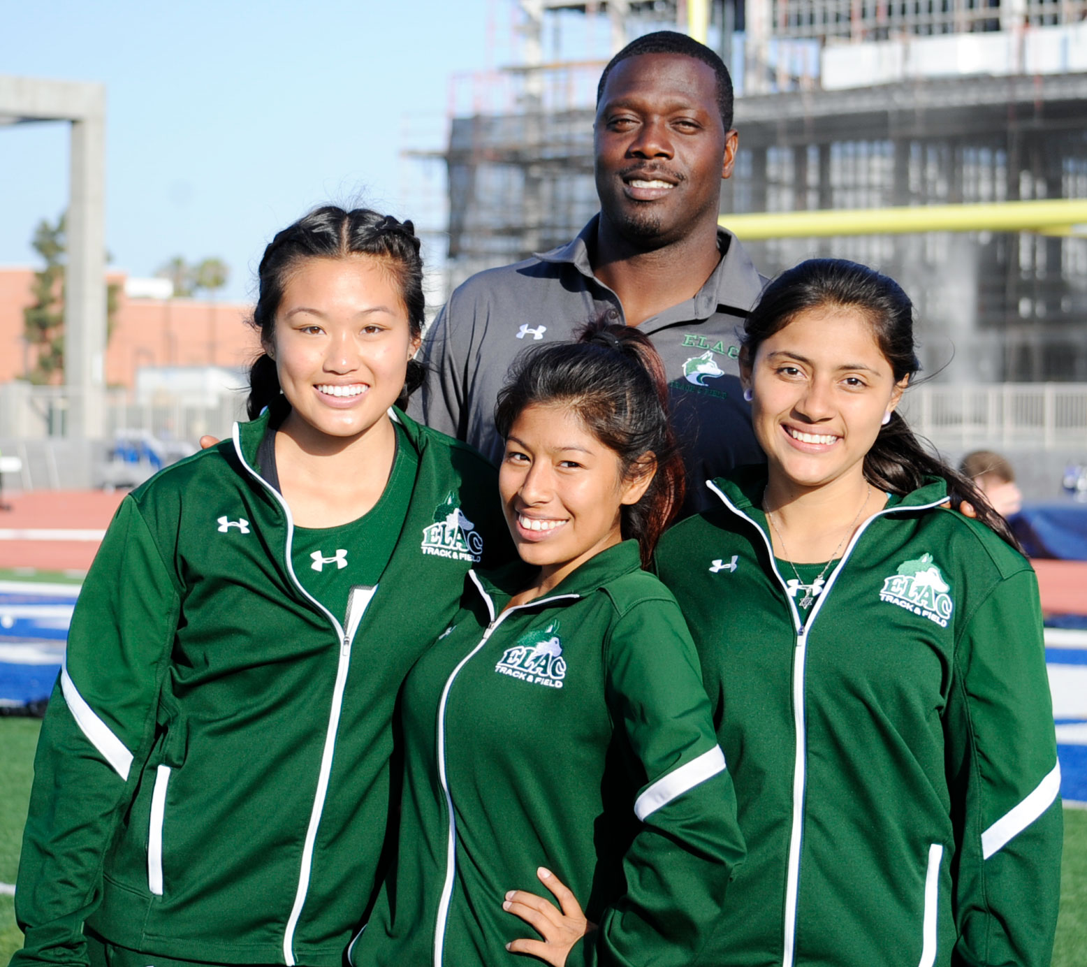 East Los Angeles College women's track and field members pictured a the South Coast Conference Championships, from left, Cameron Chang, Jazmin Romero, Coach Milton Browne and Yesenia Carias. (Photo by Tadzio Garcia)