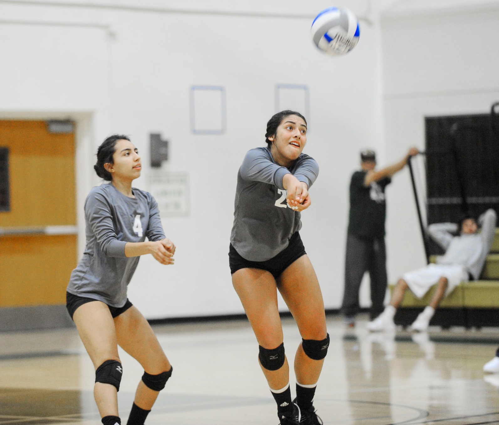 East Los Angeles College volleyball team outside hitter Miranda Moisa, right, passes the ball as libero Victoria Trejo looks on in a 3-2 five-set loss to Pasadena City College. (Photo by Tadzio Garcia)