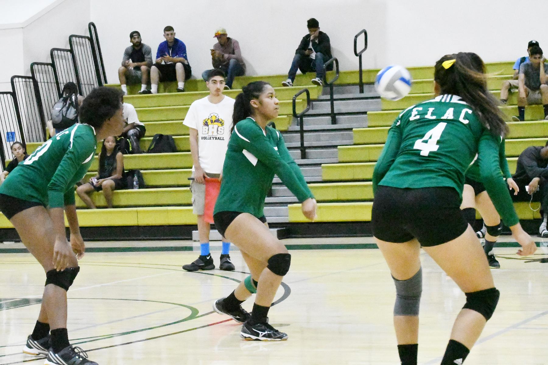 East Los Angeles College sophomore middle hitter Angela Wade (center) connects on one of her 24 digs in the Huskies 5-set win vs. the California Lutheran University JV team on Sept. 21. (Photo by DeeDee Jackson)